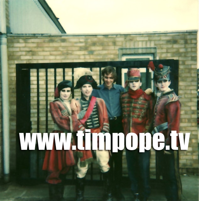 gates.jpg - Tim Pope with the band at studio gates, Battersea, from a Polaroid.
