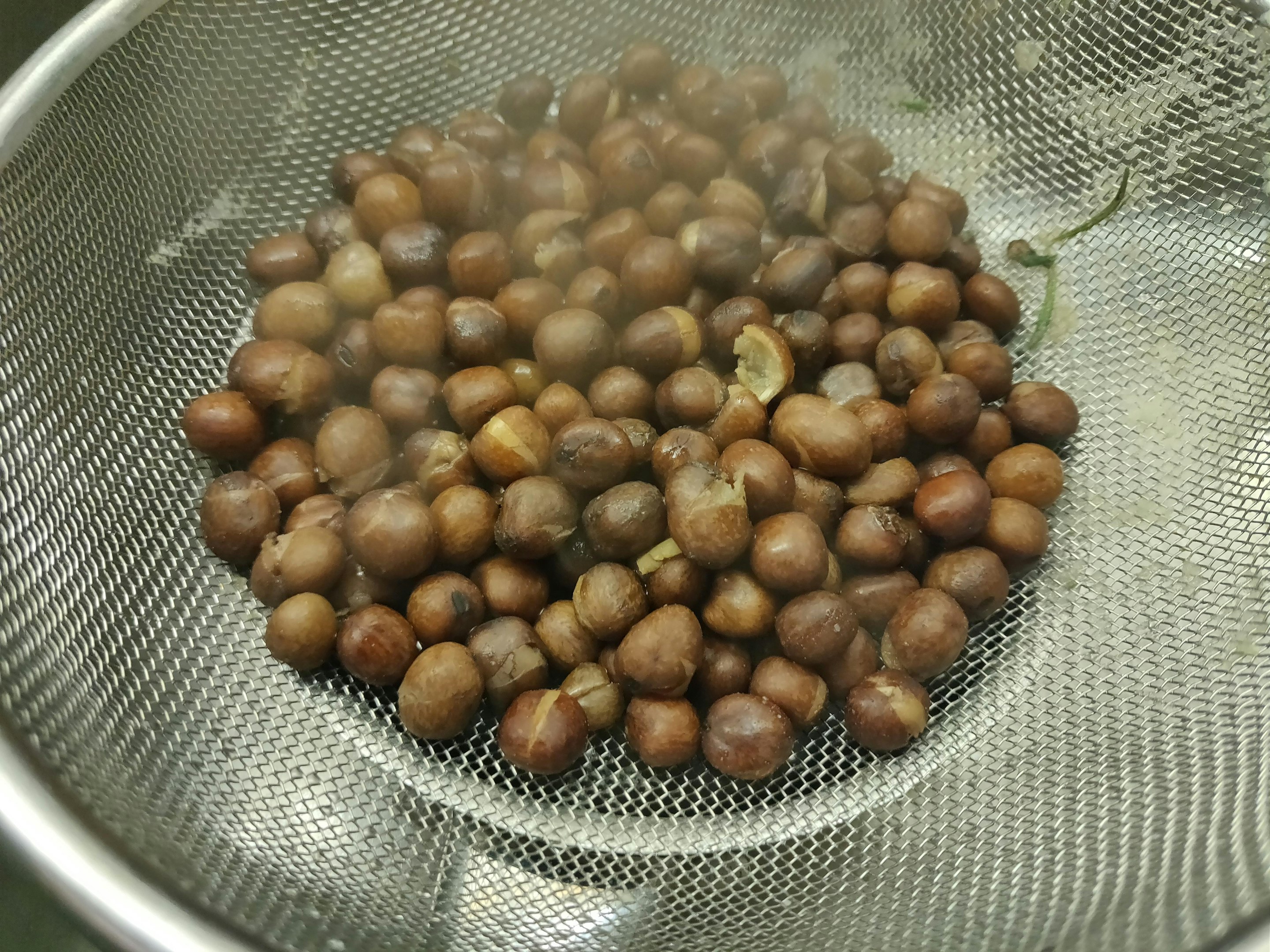 Once soft, some of the peas will have split in the water.