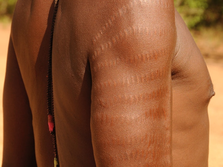 Ten rows of scars shows everyone that this rustler has killed ten enemies during cattle raids.