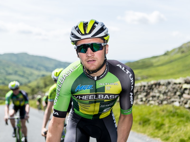Wheelbase cycle team rider, lit with studio heads from the back of a van.