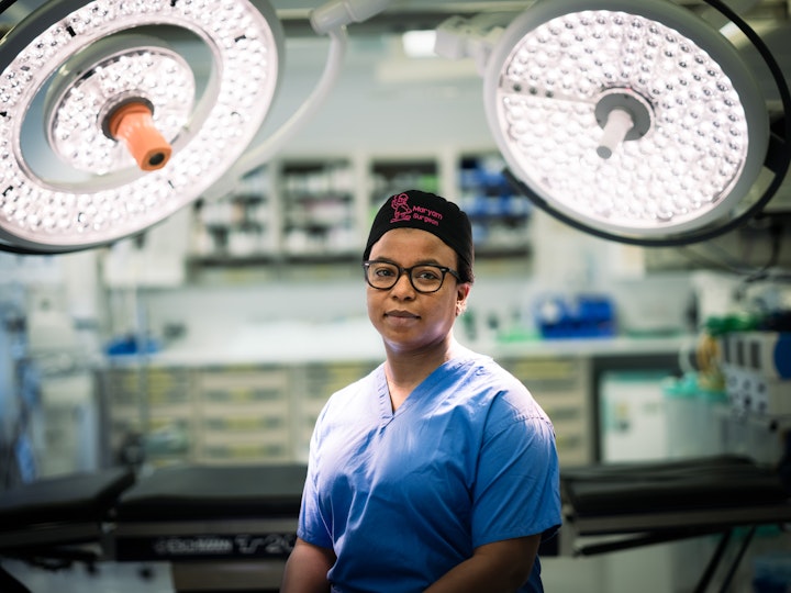 Open Britain x NHS Imperial Trust Collaboration - Maryam Alfa-Wali – Trauma Surgeon, St Mary’s
Maryam Alfa-Wali moved here from Kano, Northern Nigeria with her parents and nine siblings as a child. When her parents moved back Maryam chose to stay to pursue medicine at Cardiff University and embark on her specialist surgical training in London.
Reality struck a personal chord for Maryam to become a trauma surgeon when she lost friends at university in a road traffic collision. At the time, the UK lacked formal training programs for trauma surgeons, unlike the US. Driven by this experience, she completed a PhD and gained experience in general surgery before seeking further training in trauma surgery at the Royal London Hospital under renowned specialists. Road traffic accidents, stabbings, self-harm incidents, and falls from heights are the leading causes of trauma surgery cases in the UK.
After graduating from medical school, Maryam has dedicated over two decades to her surgical career, overcoming numerous hurdles. Most of her siblings have moved back to Nigeria but Maryam has stayed to face a more challenging way of life here both in the NHS and the everyday, including putting together IKEA flatpack furniture joked Maryam.