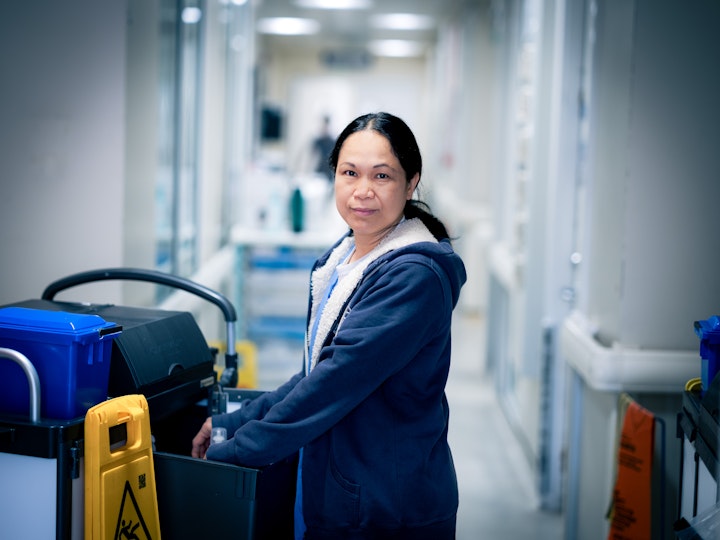 Open Britain x NHS Imperial Trust Collaboration - Mary Boking – cleaner in intensive care, Hammersmith Hospital
Mary Boking moved from the Philippines to Cyprus seventeen years ago where she worked as a domestic cleaner. Attending church on Sundays, she met Stephen, an Englishman with a holiday home there and their love blossomed over the course of four years.
Coming to the UK wasn’t easy for Mary. They had to make a bank guarantee, which meant that Stephen had to sell his holiday home in Cyprus to raise the funds.
Mary gets up at 4.45am every morning to travel from East London and works five days a week. She loves working in the hospital,. being part of a diverse team and having a more focused role.