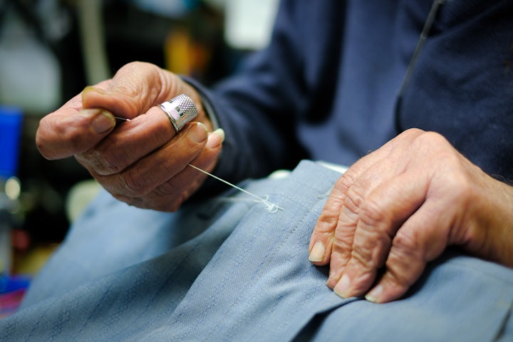 Threaded Elegance: A Tribute to London Tailoring - Andreas is an 82 year-old Greek Cypriot. He moved here from the Greek town of Famagusta in 1962. Ever since the Turkish invasion in 1974 his annual visits home have been to another country. One of 9 brothers, mostly farmers, Andreas was always more interested in the needle and thread than the hoe. Formerly in Old Bond Street Andreas has been tailoring made-to-measure suits at 39 Kilburn Lane for more than 30 years now.