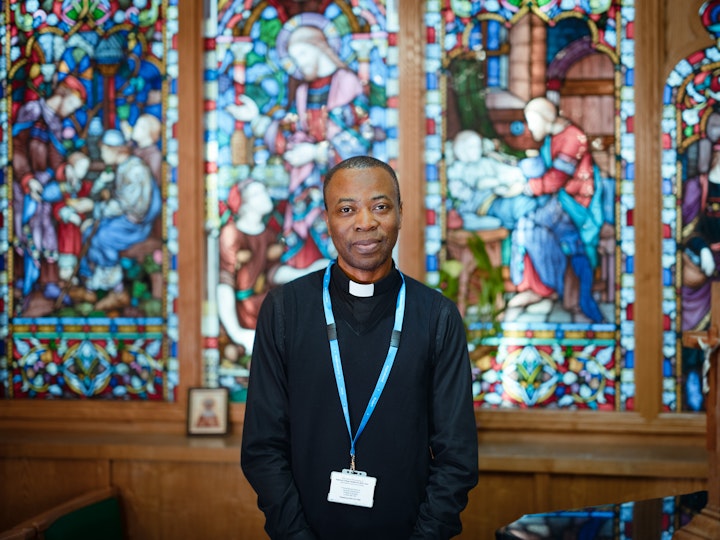 Open Britain x NHS Imperial Trust Collaboration - Father Blaise Amadi Blaze Armadi -– Roman Catholic cChaplain, Hammersmith Hospital
As a child Blaise went to boarding school in Nigeria. As early as the age of 12 he was intrigued by the school Chaplain and the attention he garnered from those around him. HSo, he felt his calling.
Blaise was a priest in Nigeria for seven years. He went as a supply priest to Italy before being called to the UK in 2012 to be an assistant-parish priest in various churches around London and Manchester.
Father Blaise is a Vincentian Catholic priest , their calling is to work with the poor, the marginalised and the sick. The path to hospital chaplain was therefore an obvious one.
Father Blaise cCelebrates Mass, and the sacrament of reconciliation in the hospital chapel as well as providing spiritual and pastoral support for patients and their families. He also administers Notably administering the last rites so that those passing ‘do not feel abandoned in their final moments’.