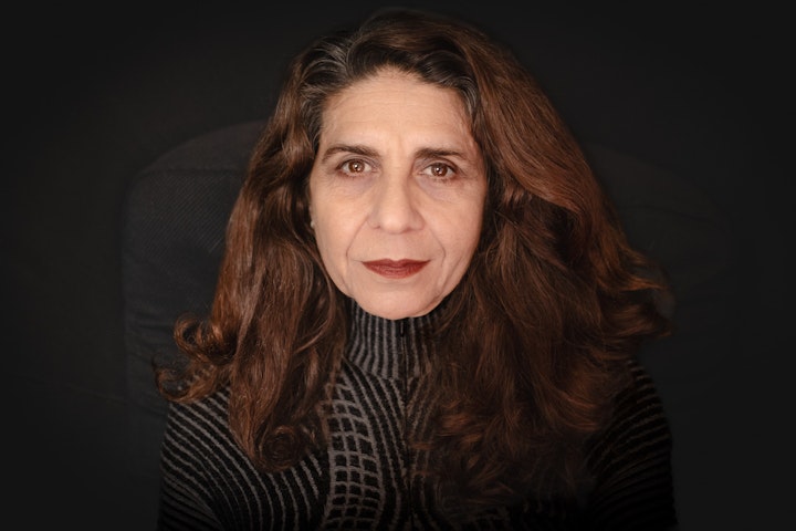 Open Britain: Portrait of a Diverse Nation - Neda Southgate (Neda Al Atar) was born in Southern Iraq in 1963. One of 14 children, her father was a wealthy textile merchant. She was studying social sciences at Basra university when Sadam Hussein, as part of his persecution and oppression of Shia Muslims and preparation for war against Iran, deported Shias in their masses. Nedas family were amongst them.
The family’s Iranian heritage meant their wealth and property were all confiscated by the regime. Neda’s mother had no Iranian heritage and had serious health issues, so was permitted to stay. She was forced to leave their family home.
Neda never saw her mother again.
After a short period of incarceration, Neda fled through the desert across the border into Iran where she was reunited with those family that had already left. However, these were difficult times due to war and the authoritarian theocratic rule of the Ayatollah Khomeini. After 3 years they fled to Syria. Neda’s imprisoned brother had leukaemia and with the aid of the Red Cross came to the UK. He in turn helped the family join him as refugees.
In the UK Neda studied architecture part time whilst working in an architects practice. However, after a couple of years she noticed the lack of equality in this male dominated environment. She switched to study Fashion at Central St Martins and designed clothes for private clients.
After the birth of her two children, she started to work in childcare and set up a nursery. Unfortunately, Neda had to close it due to illness. After some deep reflection, she decided that her calling was to work in a humanitarian field. Neda volunteered at the Martlets Hospice, Brighton, providing creative therapy.
Neda went on to train and work with the Alzheimer’s society for 3 years, providing therapeutic care. And when the Brighton office closed, she opened her own business ‘Alzheimer’s with Compassion’ whilst continuing to train.
Neda has worked in the fields of psychology, architecture, fashion design and childcare. But it is when she started talking about working with people with Alzheimer’s and dementia that she sat up and really came alive.