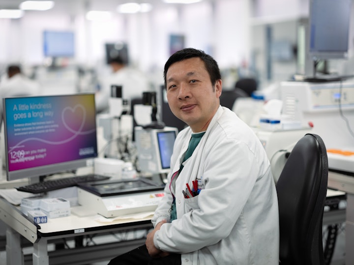 Open Britain x NHS Imperial Trust Collaboration - Kui Kee Lam -– aAssociate pPathology pPractitioner, Charing Cross
Kui Kee Lam was born in Hong Kong. The UKnited Kingdom has granted Hong Kong Nnationals the right to live here if they who hold a British National Overseas Passport –, something they had to apply for before 1997 when Hong Kong was returned to China, the right to live here. The well reported crackdown on civil liberties and freedom of speech and a deep unhappiness with his two children’s education in Hong Kong, led to Kui and his family moving to South LondonSutton in 2021.
Kui has been working in this field for more than 20 years but in order to reach the level he heldwas in Hong Kong, he must improve his English further.
Kui works in hHistopathology or cellular pathology, which is. Histopathology is the diagnosis and study of diseases of the tissues, and involves examining cells under a microscope. Kui is responsible for embedding, trimming, cutting, block checking, labelling and filing specimens so they can be sent to athe consultant for diagnosis, mostly in oncology but also post-mortem.