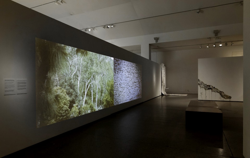 Gurangatch and Mirragan - Aunty Sharyn Halls with Craig Bender and Vera Hong. Gurangatch and Mirragan (2017-2022). 4’43” Single channel HD video. Stereo audio. Water presence & absence exhibition, Blue Mountains Cultural Centre. Installation Photo: Silversalt Photography