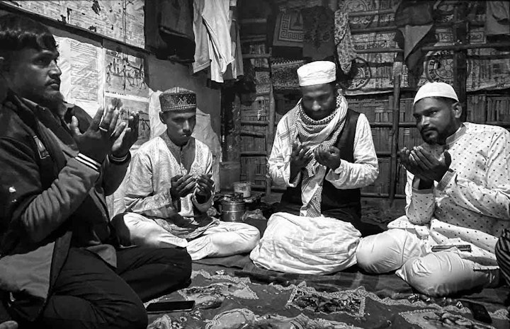 The marriage ceremony. The grooms sits with the molvi. The bride sits in an adjoining room and is able to listen to the molvi. Image by Mohammed Salim Khan.