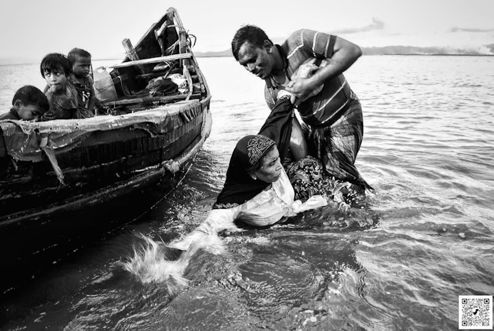 2017: This woman escaped Myanmar with only her grandchild. Her body was shaking when she disembarked. Photo by Abul Kalam.