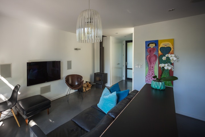 The Black House part one - The natural woodburning fire also heats the hot water at this small eco home in Queenstown designed by Architect Stacey Farrell the floor is also tinted black for maximum solar gain