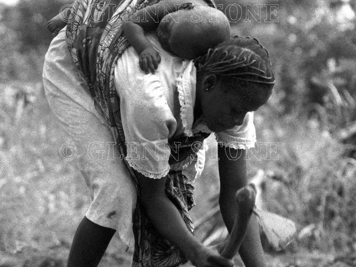 Traditional agriculture - Young mother planting sorghum. Tiv, Nigeria.