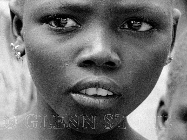 Nigeria - Kofyar girl, Lardang Goetoeng village. Note anthropologist leaning out of Land Rover reflected in her eye.