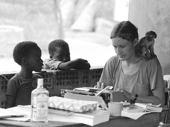 Nigeria - Anthropologist with baby monkey typing fieldnotes. Plateau State, Nigeria, 1984.