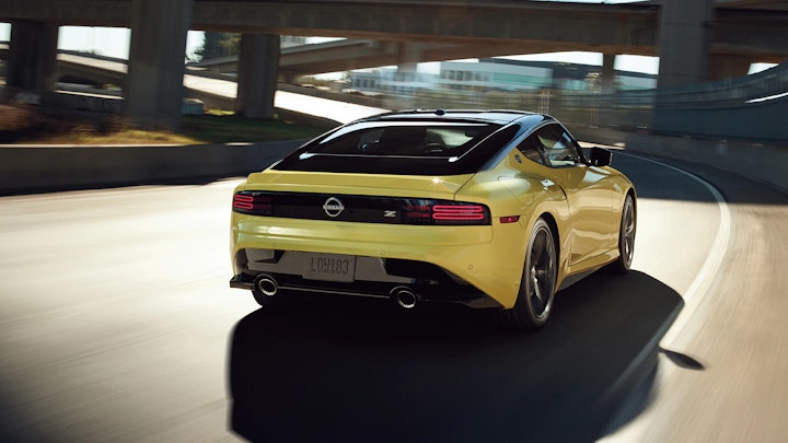 Hi, I'm Roger - 2023-nissan-z-in-yellow-driving-on-a-highway-with-two-tone-exterior-l