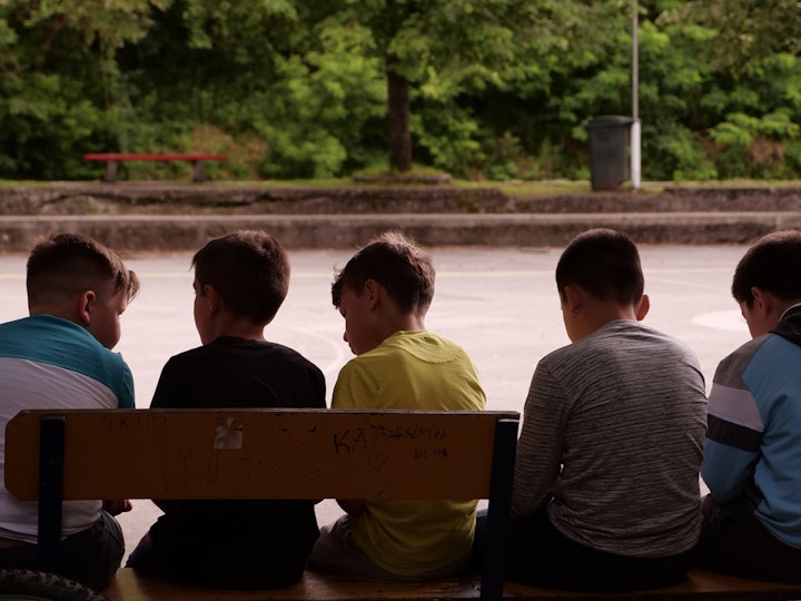 Kids sitting on a bench in the People's Heroes Park