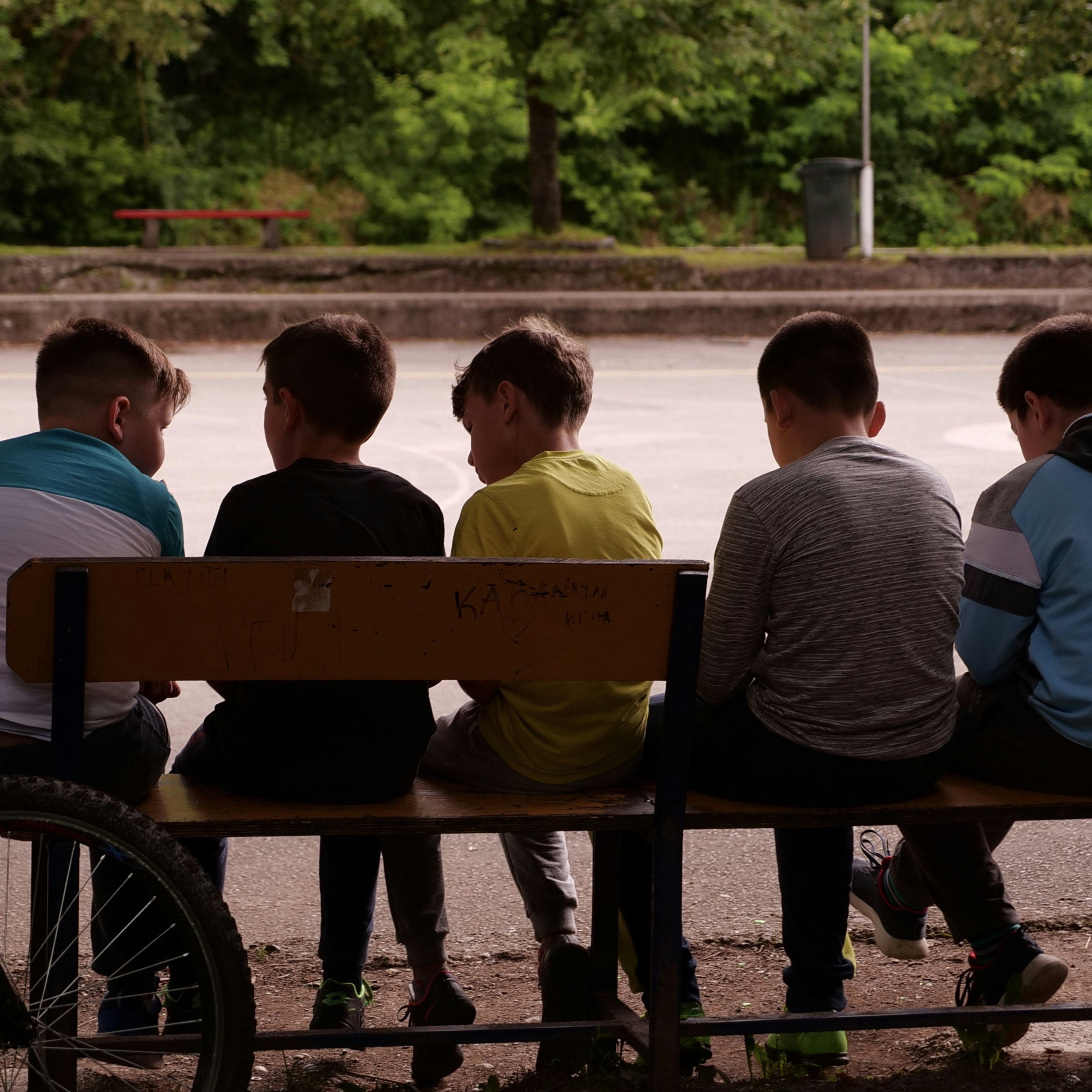 Kids sitting on a bench in Prijepolje Kids sitting on a bench in Prijepolje