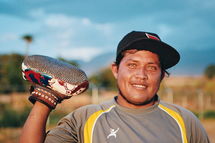 El Biche holds his five kilo glove up for me. Every Sunday, several mini-tournaments of 'La Pelota Mixteca' get played around the southern state of Oaxaca. It's a five-a-side game played on a pitch that's roughly 11 metres wide by 100 metres long, with the same point system as tennis.

You can see a trailer for the documentary 'Los Jugadores' (The Players) I made last year below. It was recently accepted into the Ethnografilm Festival in Paris, which will screen next April.

https://vimeo.com/496491623
http://www.ethnografilm.com/