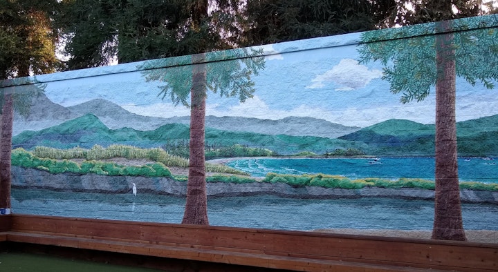 The conceit with the painted redwood trees is that they are continuous above the wall. In certain lights and certain angles, it's almost believable.