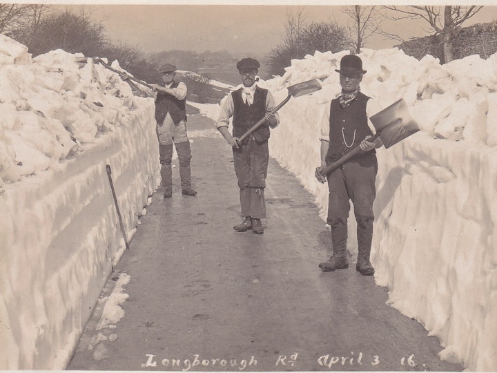 Postcard (J. W. Farrall, Stow-on-the-Wold) of men clearing Longborough Road of snow in Moreton-in-Marsh in the Cotswolds on April 3rd 1916