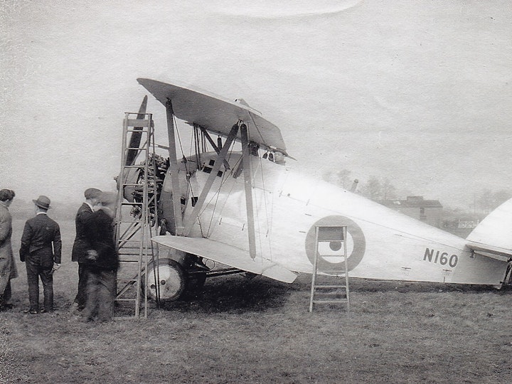 A photograph of an old photo or postcard of the 'Parnall Plover' designed by George Parnall, the man in the image with the trilby hat that was built at his factory in Yate on Station Road