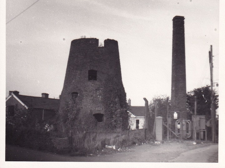 Photograph taken in 1972 of the Windmill Tower and chimney stack at Frampton Cotterel