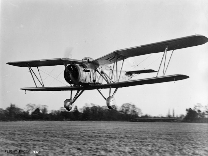 Photograph of the G.4/31 general purpose biplane K2772 making a low pass over Yate  aerodrome, flown by test pilot Captain Howard Saint. Powered by a 690hp Bristol Peagus IM3 radial engine. The G.4/31 was designed by H.V. Clarke who replaced Harold Bolas. It was the last aircraft designed and built by George Parnall & Co.