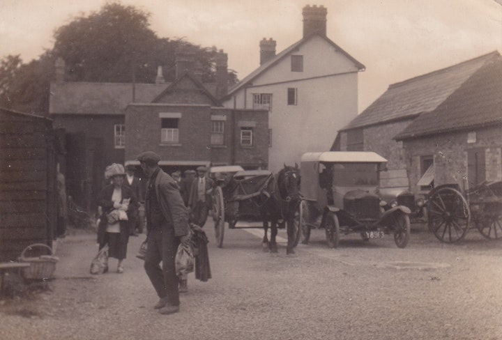Market Day at Charfield in Gloucestershire in the yard of the Railway Tavern. This is not strictly a postcard but rather photograph printed on card