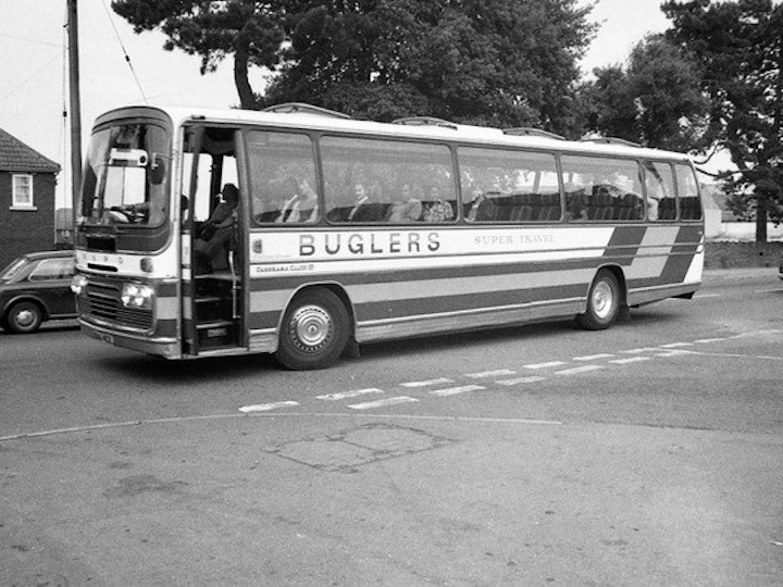 From the Alan Jordan Collection (Bob's nephew), this photograph captures a Ford/Plaxton Panorama of Buglers Coaches departing Newman Industries ate end of the afternoon shift.
The exit to the car-park stands where the junction of Eggshill Lane and Station Road and is taken from outside the old Co-Op (now Tesco Express). The site of the car park is now Mow Barton.
At the time (early 1980’s), Newmans, like many other major employers, operated a network of bus services exclusively to provide their employees transport to/from work. The end of the shift would often see the car park empty of all cars and numerous buses and coaches within a 10-15 minute period!