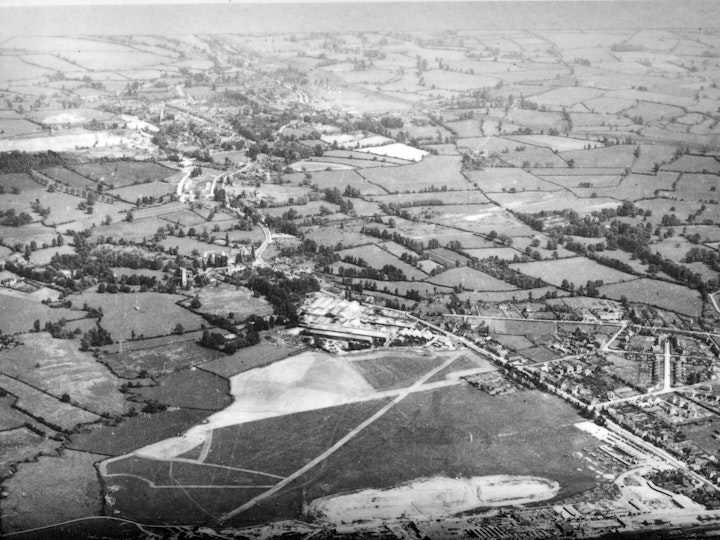 Aerial photograph from at least the early 1940s (prior to the Wapley Inland Sorting Depot - A.K.A. Sea Transport Stores) showing the Yate Aerodrome with the runway running diagonally across with Parnalls factory in the foreground and Newmans factory in the centre of the image both linked by Station Road. 
Yate Chemical Works can be seen on Eggshill Lane that links Station Road with Westerleigh Road which runs more or less horizontal from Newmans Factory to the edge of the centre of the image on the right. Blakeney Saw Mills on Westerleigh Road can be seen opposite the junction with Eggshill Lane.
Stanshawes Drive can be seen heading east from Westerleigh Road towards Stanshawes Court. Where the Drive becomes tree lined heading up to the Court there is a small road heading south which went to Stanshwes Farm, where Bob's father was born in 1900.