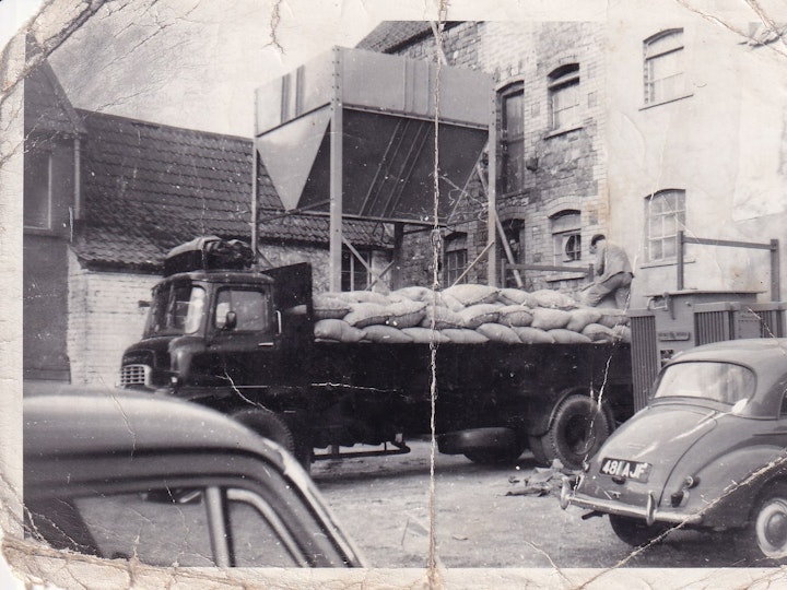 Photograph of grain been loading onto a truck at the Cow Mills on Station Road Yate.
