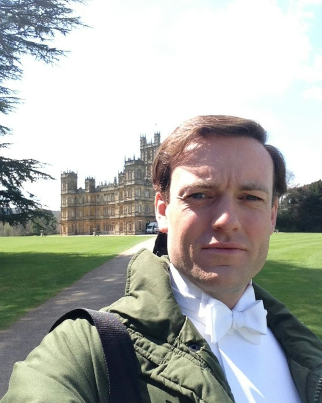 Brendan Patricks walking away from Downton Abbey in daylight'