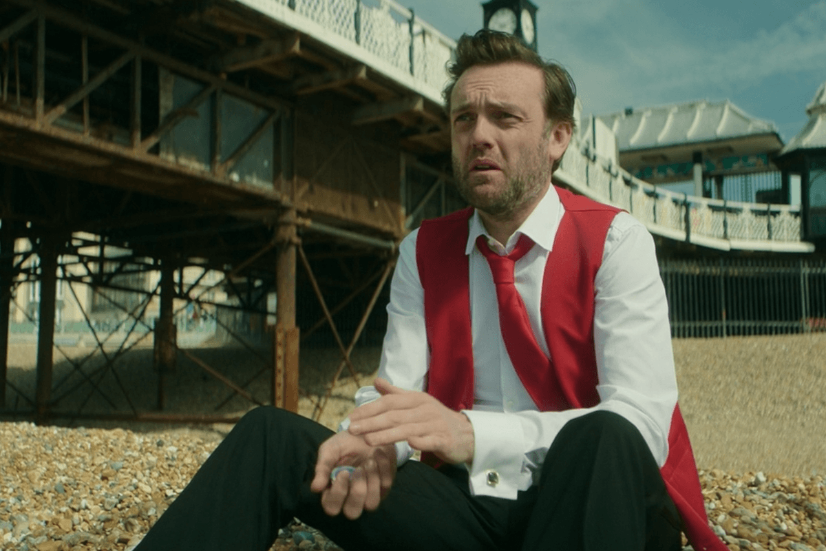 Brendan Patricks playing a magician character in Grace on Brighton pier