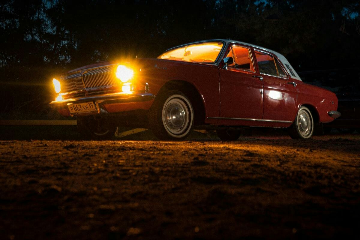 A red car in darkness on the Downton Abbey grounds