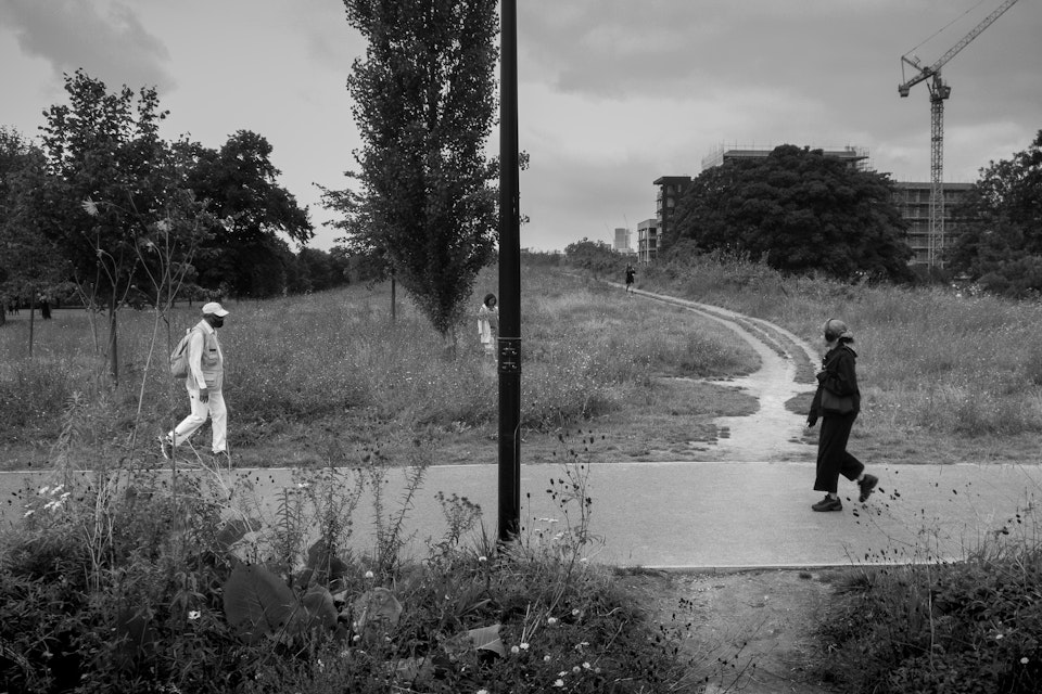 Street Folio I - Four people walk along various pathways in Burgess Park, south London