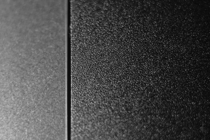Macro super-closeup of a computer trackpad in black and white.
