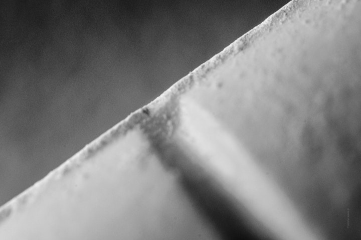 Macro super-closeup of a medical tablet in black and white.