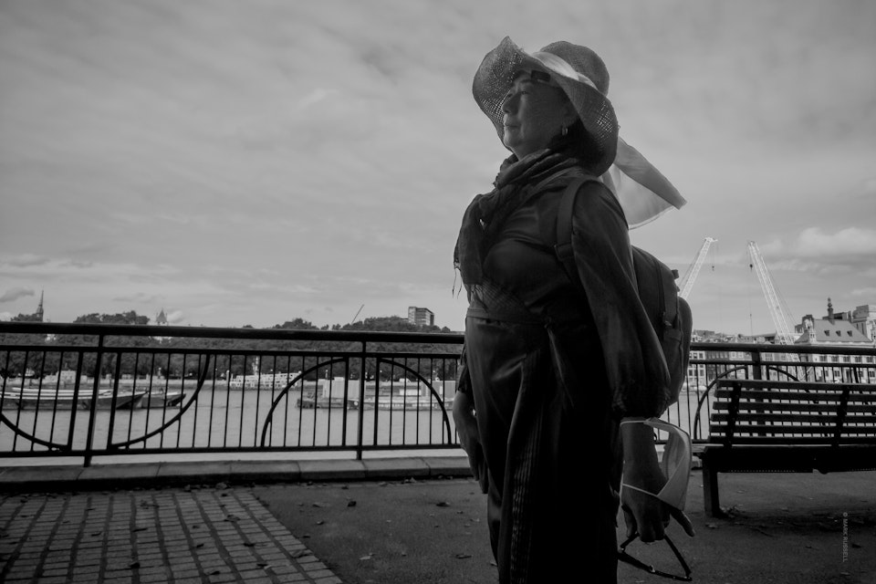 Street Folio I - A woman walks along the Queens Path by the thames, near the Oxo Tower in London