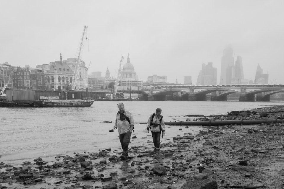 Street Folio II - Beachcombers search the south bank of the river Thames in London