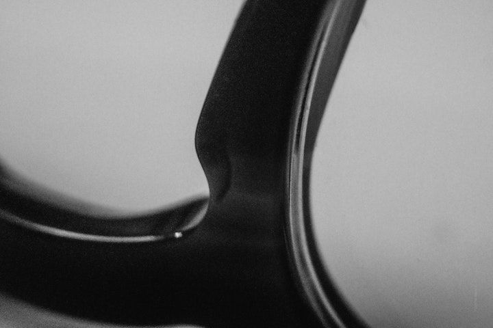Macro super-closeup of the bridge of a pair of glasses in black and white.