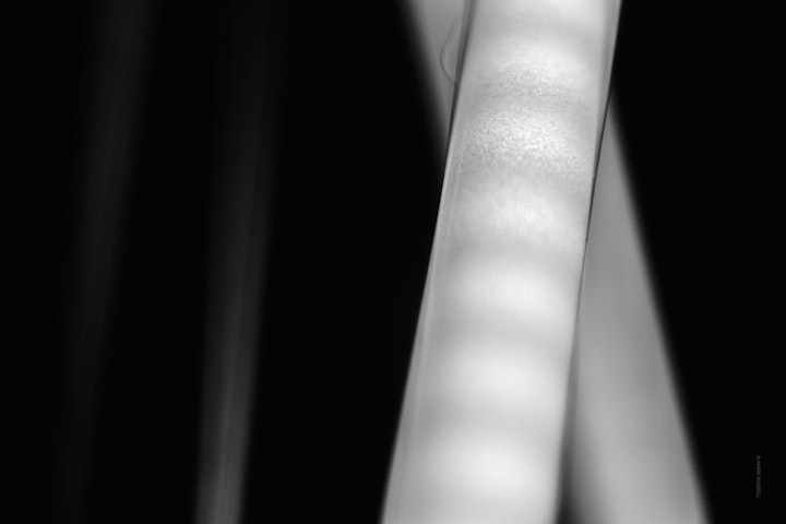 Macro super-closeup of LED bulb filaments in black and white.