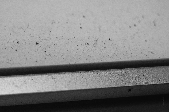 Macro super-closeup of a dusty computer keyboard in black and white.