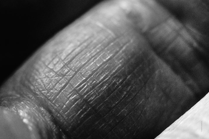Macro super-closeup of the skin on a finger in black and white.
