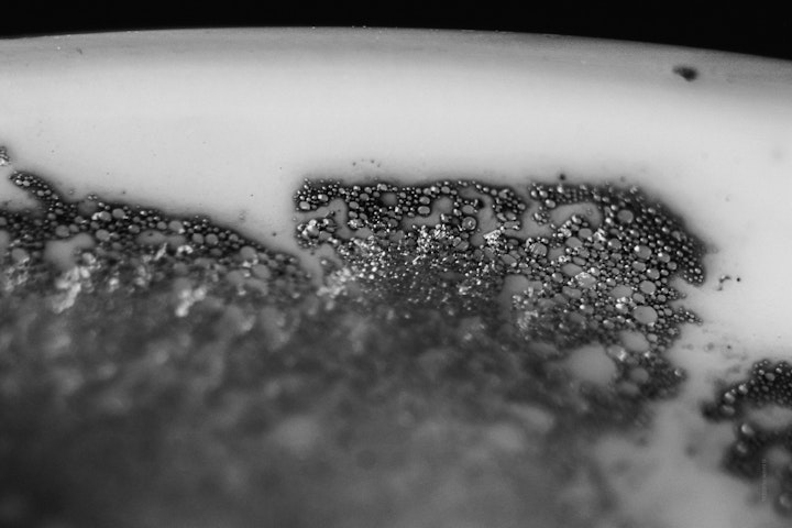 Macro super-closeup of a coffee cup in black and white.