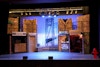 In the Heights - The whole set. The store fronts and balconies above were set on steel deck. The George Washington bridge was custom printed on a white vinyl strip and placed against a white cyclorama.