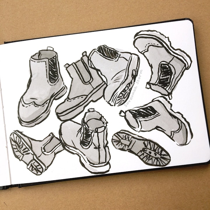 Sketchbooks - A sketchbook page with drawings of a boot from lots of different angles, illustrated using ink.