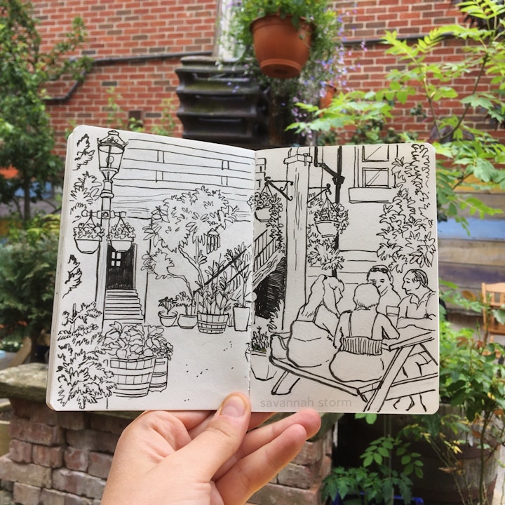 Sketchbooks - A sketchbook page of a group of people sitting in a plant filled pub garden, illustrated using ink pen.