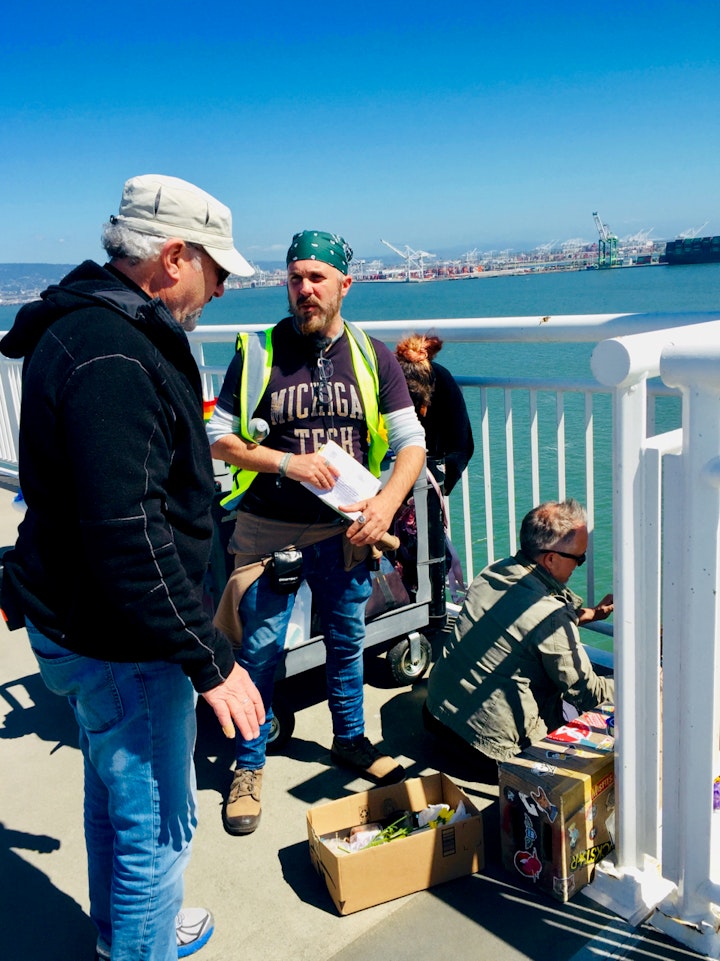 Discussing the next set up on the Bay Bridge while production designer Rob Riutta and art assistant Rachel Groat dress the set.