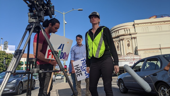 Our fearless cinematographer Sherri Kauk positioned to film with actors Cameron Matthewa and James Liao (l, r) on the median.