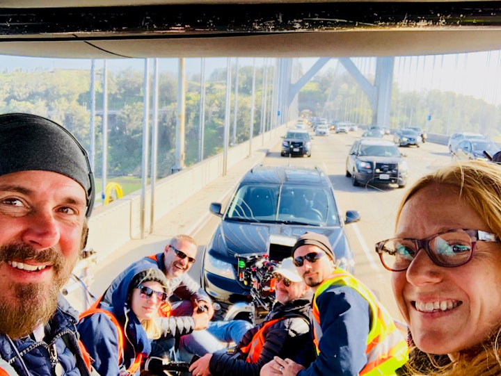 ACROSS crew on the Bay Bridge from clockwise: Cinematographer Steve Condiotti, Key Grip Jason Noel, First Assistant Camera Kiersten Lane, Director Matthew Riutta, Second Assistant Camera Christa Pedersen, and Producer Jerremy Stewart.  Actor Ahku is in the vehicle behind as California Highway Patrol provides a safety buffer around our low tow dolley provide by Ducey Productions.