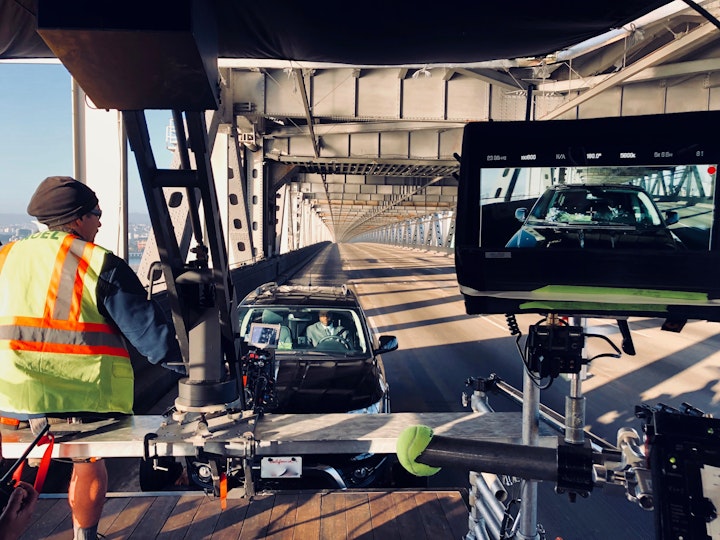 Filming on the very empty Oakland Bay Bridge with the help of California Highway Patrol (thank you!).  Key grip Jason Noel has got the prime seat, while actor Ahku runs his scene.